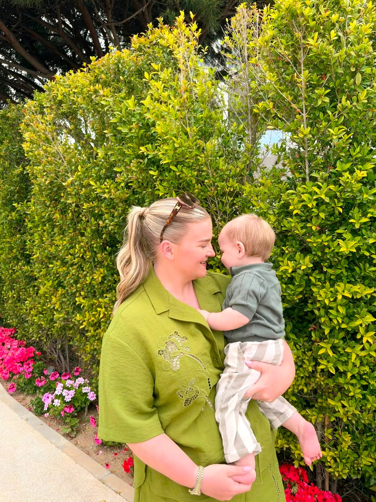 Emma holding her little boy outdoors